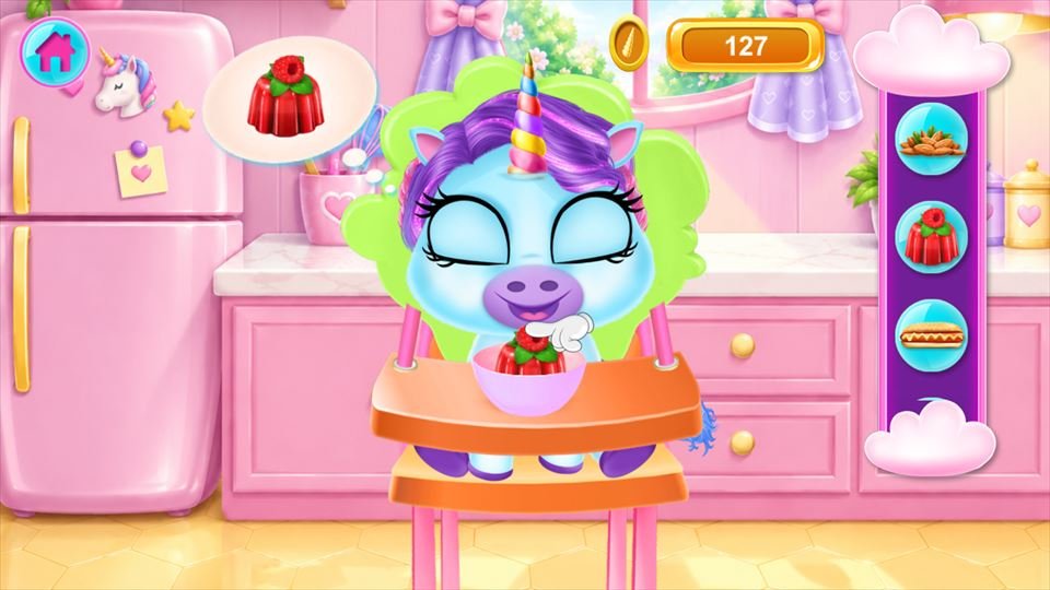 Screenshot 1 of Baby Rainbow Unicorn Care Game: a baby unicorn eating in a high chair in a pink kitchen